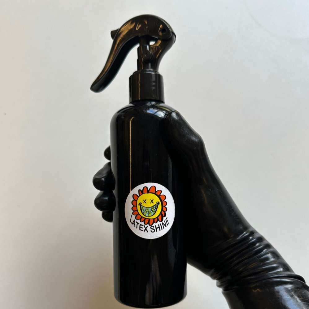 latex gloved hand holding spray bottle of latex shiner